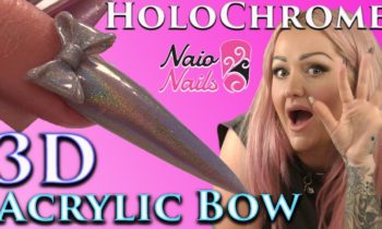 Holographic Chrome Acrylic Bow on a Stiletto Nail.