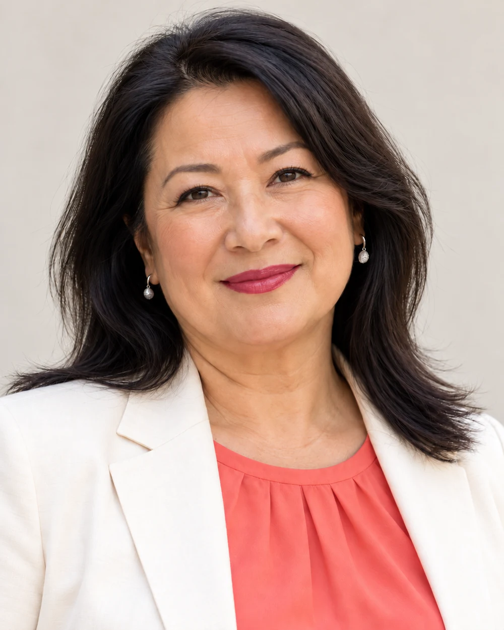 A fictional mature woman with light warm-neutral skin, dark hair and full facial proportions wearing a thin plum lash line and clear berry satin lips beside ivory and coral.