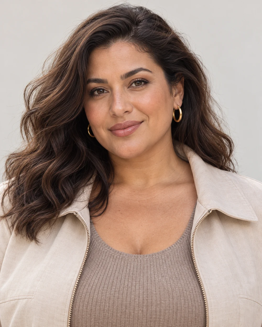 A fictional woman with light-medium warm olive skin, dark waves and full facial proportions wearing soft cocoa outer lids, small bronze centres and rose-brown lips with taupe layers.
